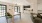 a large living room with a dining table and chairs