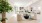 a large living room with a large white floor and a large tree