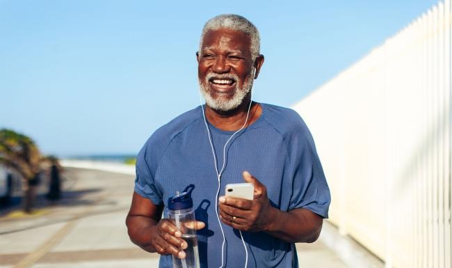 a man holding a water bottle while outdoors