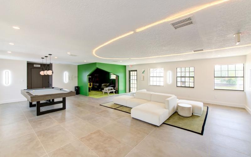 a large room with a bed and a desk