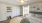 a bedroom with a fan and a couch